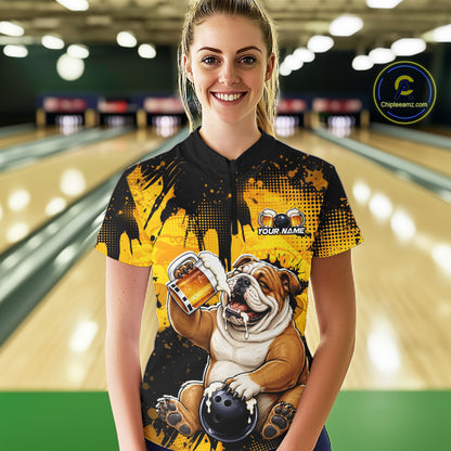 Person wearing a bowling shirt with a bulldog design in a bowling alley.