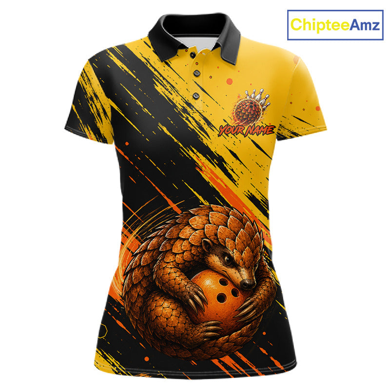 A women's short-sleeve polo shirt with a yellow and black brushstroke design, featuring a large 3D-style pangolin graphic holding a bowling ball on the front. The shirt has a black collar and a custom logo on the left chest.