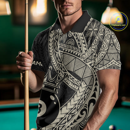 Man holding a pool cue while wearing a black and gold polo shirt covered in intricate Polynesian-inspired tribal patterns and a large crowned 8-ball graphic near the hem.