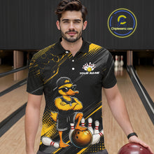 Load image into Gallery viewer, Man wearing a black and yellow bowling shirt with a duck design in a bowling alley.