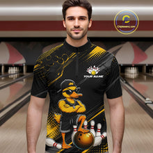 Load image into Gallery viewer, Man wearing a black and yellow bowling shirt with a duck design in a bowling alley.