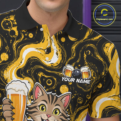 A close-up of a person wearing a black and yellow marbled polo shirt with a cartoon cat holding a beer glass and a customizable name patch on the chest. 