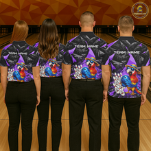 Load image into Gallery viewer, Four people wearing matching bowling shirts with colorful parrot designs on a bowling alley.