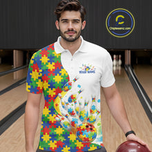 Load image into Gallery viewer, Male model in a bowling lane wearing a white polo shirt, front view featuring colorful autism bowling strike design with puzzle details