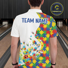Load image into Gallery viewer, Male model at a bowling lane, back view of white polo shirt showcasing autism-themed bowling strikes with colorful puzzle graphics