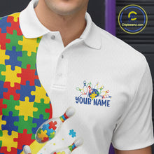 Load image into Gallery viewer, Close-up left chest detail of white bowling polo shirt featuring colorful autism bowling strike emblem with puzzle accents