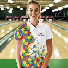 Load image into Gallery viewer, Female model in a bowling lane wearing a white polo shirt, front view highlighting autism-themed bowling strikes and colorful puzzle graphics