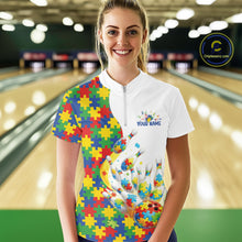 Load image into Gallery viewer, In a bowling lane, female model wearing a quarter-zip shirt, colorful autism-themed bowling strikes artwork with puzzle-inspired graphic elements.
