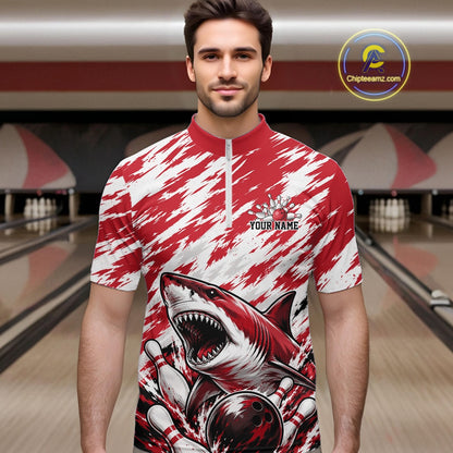 Man wearing a red and white shirt with a shark design in a bowling alley.