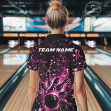 Load image into Gallery viewer, Back view of a female model in a black bowling polo shirt displaying fiery bowling artwork with pink paint accents.