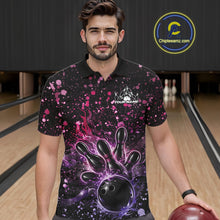 Load image into Gallery viewer, Male model wearing a black bowling polo shirt at the lane with fiery bowling artwork and pink-purple paint splatter details.