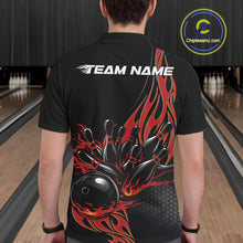 Load image into Gallery viewer, Back view of a male model in a bowling lane wearing a black polo shirt featuring red flaming black bowling ball striking pins with bold bowling visuals.