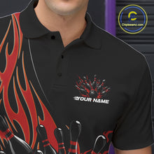 Load image into Gallery viewer, Close-up view of the left chest of a black bowling polo shirt showing red flaming black bowling ball striking pins detailed artwork.