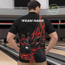 Load image into Gallery viewer, Front view male model at bowling venue wearing black quarter zip shirt showcasing red flame bowling ball striking pins in dynamic motion design.