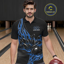 Load image into Gallery viewer, Male model seen from the front in a bowling lane wearing a black polo shirt featuring a blue flaming black bowling ball striking pins in a dynamic sports scene.