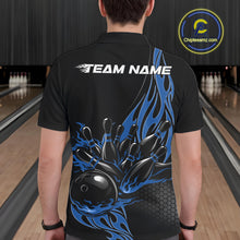 Load image into Gallery viewer, Male model seen from the back in a bowling lane wearing a black polo shirt featuring a blue flaming black bowling ball striking pins in a dynamic motion design.