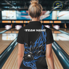 Load image into Gallery viewer, Back view female model at bowling lane wearing black quarter zip shirt featuring blue flaming bowling strike graphics