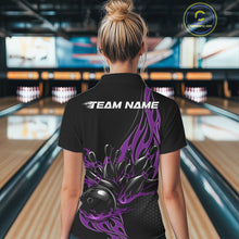 Load image into Gallery viewer, Female model back view in a bowling lane wearing a black polo shirt featuring a purple flaming black bowling ball striking pins in bold motion artwork.
