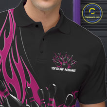 Load image into Gallery viewer, Close-up view of the left chest area of a black polo shirt showing a pink flaming black bowling ball and pins design detail.