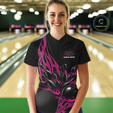 Load image into Gallery viewer, Female model front view in bowling alley wearing black quarter zip shirt featuring pink flame bowling ball hitting pins illustration