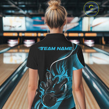 Load image into Gallery viewer, Female model back view in bowling center wearing black and blue polo shirt showcasing flame bowling ball striking pins in vivid sports illustration.