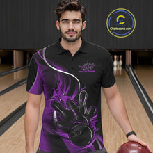 Load image into Gallery viewer, Male model seen from the front in a bowling lane wearing a black and purple polo shirt featuring a flame bowling ball striking pins in a dynamic sports scene.