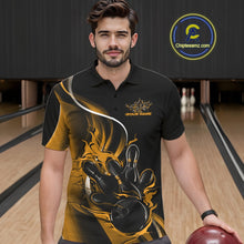 Load image into Gallery viewer, Male model seen from the front in a bowling lane wearing a black and yellow polo shirt featuring a flame bowling ball striking pins in a dynamic sports action scene.