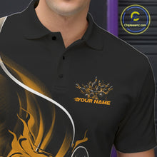 Load image into Gallery viewer, Close-up view of the left chest area of a black and yellow bowling polo shirt showing a flame bowling ball and pins design detail.