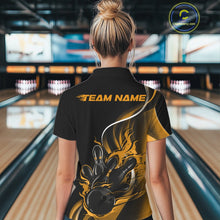 Load image into Gallery viewer, Back view female model inside bowling center wearing black and yellow quarter zip shirt with flame bowling ball and pins action graphics