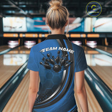 Load image into Gallery viewer, Back view of a women s black and blue bowling quarter zip with honeycomb pattern and flame bowling ball striking pins graphics in a bowling alley.