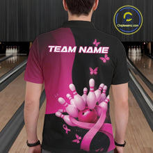 Load image into Gallery viewer, Back view of a male model in a bowling venue wearing a black and pink polo shirt, showcasing awareness ribbon and butterfly bowling design elements.