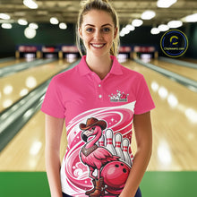 Load image into Gallery viewer, Female model at a bowling lane wearing a pink bowling polo shirt with a cowboy flamingo and bowling ball design.