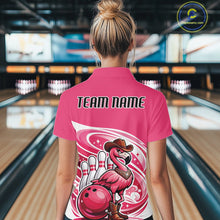 Load image into Gallery viewer, Back view of a female model in a bowling center wearing a pink quarter-zip shirt featuring a cowboy flamingo leaning on a bowling ball.