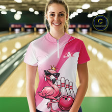 Load image into Gallery viewer, Female model wearing a pink bowling quarter-zip shirt at a bowling lane with a crowned flamingo in sunglasses and a bowling ball design.