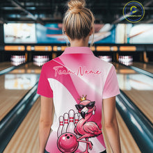 Load image into Gallery viewer, Back view of a female model in a bowling venue wearing a pink quarter-zip shirt featuring a crowned flamingo and bowling ball artwork.