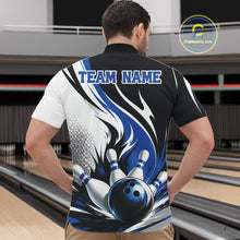 Load image into Gallery viewer, Male model wearing a white, black, and blue bowling quarter zip shirt with a flaming bowling ball knocking down pins graphic, shown from the front at a bowling lane.
