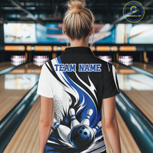 Load image into Gallery viewer, Back view of a female model wearing a white, black, and blue bowling quarter zip shirt with a flaming bowling ball knocking down pins graphic at a bowling lane.