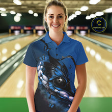Load image into Gallery viewer, Female model at a bowling lane wearing a blue and black bowling polo shirt with butterfly artwork, a bowling ball, and pin graphics.