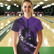 Load image into Gallery viewer, Female model at a bowling lane wearing a purple and black quarter-zip bowling shirt with butterfly artwork embracing a bowling ball and pins.