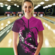 Load image into Gallery viewer, Female model wearing a pink and black bowling quarter-zip shirt at the bowling lane with butterfly artwork surrounding a bowling ball and pins.