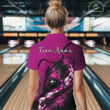 Load image into Gallery viewer, Back view of a female model in a bowling alley wearing a pink and black quarter-zip shirt featuring a butterfly, bowling ball, and pin motif.