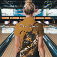 Load image into Gallery viewer, Back view of a female model in a bowling center wearing a yellow and black polo shirt featuring a butterfly wrapped around a bowling ball.