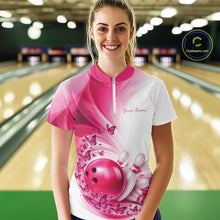 Load image into Gallery viewer, Front view of a female model in a white and pink bowling quarter zip featuring butterfly artwork and bowling graphics inside a bowling alley.