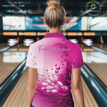 Load image into Gallery viewer, Back view of a women s white and pink bowling polo shirt displaying butterfly accents and bowling graphics inside a bowling alley.