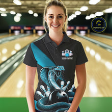 Load image into Gallery viewer, Female model wearing a black bowling polo in a bowling center with blue cobra graphics and bowling pin details.