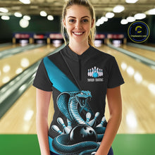 Load image into Gallery viewer, Female model at the bowling lane wearing a black quarter-zip decorated with blue cobra artwork and bowling graphics.