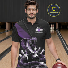 Load image into Gallery viewer, Male model at the bowling alley wearing a black bowling polo with purple cobra artwork and bowling pin graphics.