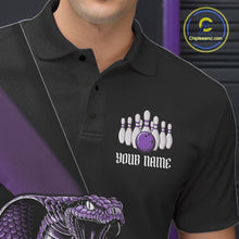 Load image into Gallery viewer, Close-up of the left chest on a black bowling polo featuring a purple cobra and bowling ball motif.