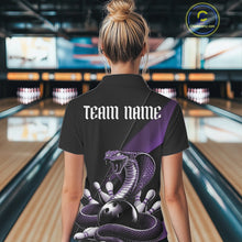 Load image into Gallery viewer, Back view of a black womens bowling polo displaying a purple cobra wrapped around a bowling ball with scattered pins.