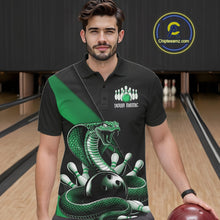 Load image into Gallery viewer, Male model wearing a black bowling polo in a bowling lane with green cobra artwork and bowling-themed details.